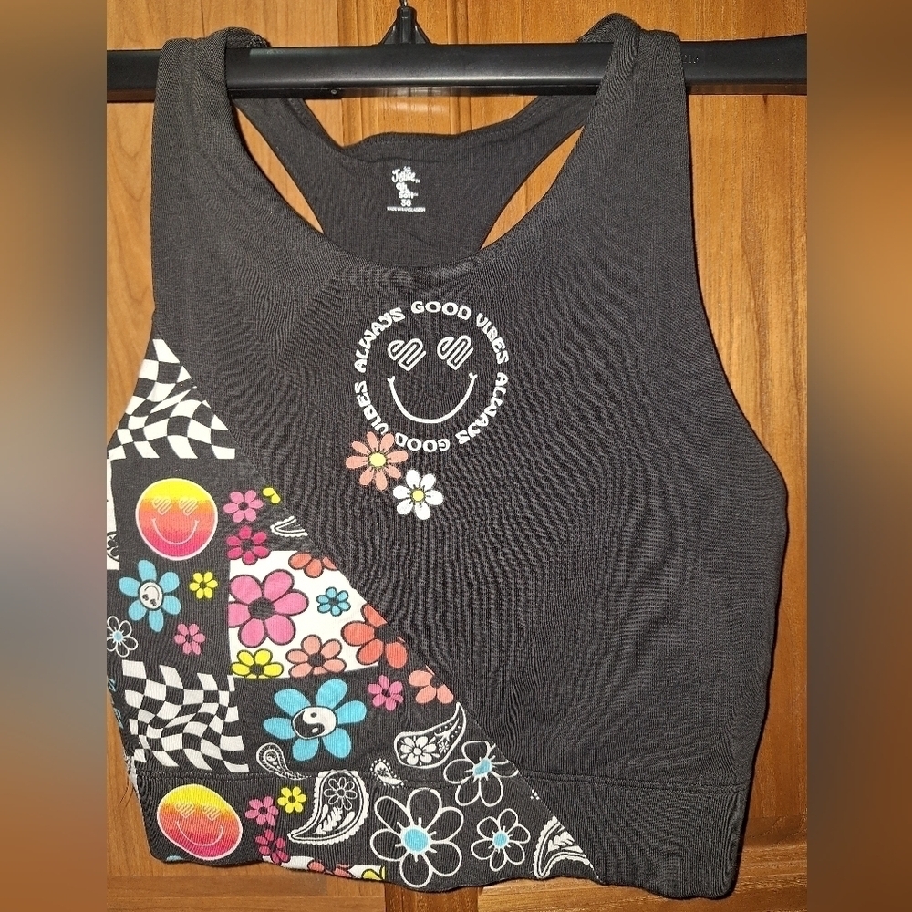 A Justice size 36 sport bra. Featuring  a floral pattern smiley face, good vibes